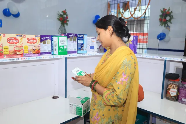 A closer look at an item during a quiet moment inside the pharmacy. — Juran Chapra, Muzaffarpur
