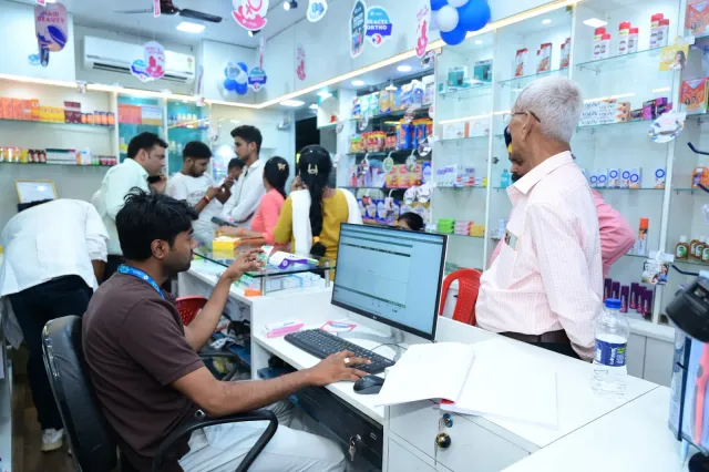 A glimpse of computer work and coordination behind the counter. — Gola Road