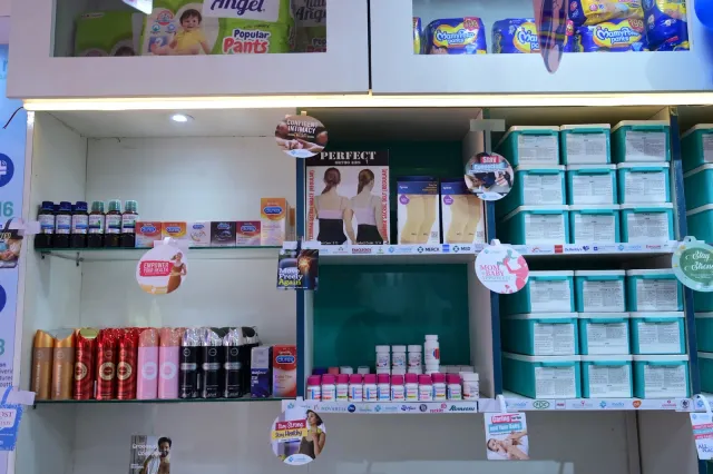 Products and aqua storage drawers line the pharmacy shelves. — Gola Road