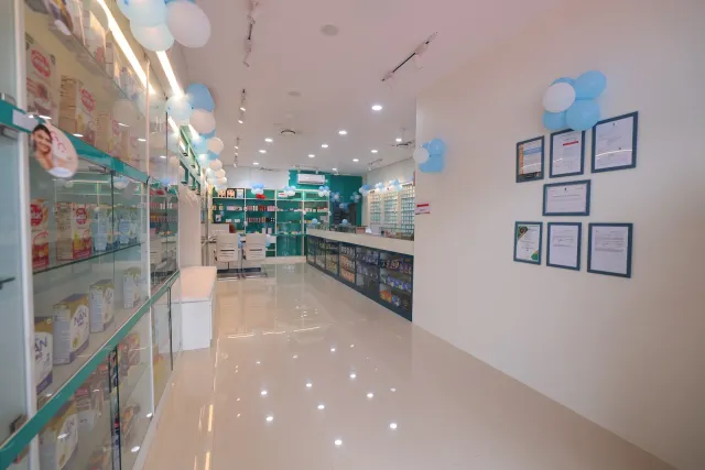 A bright aisle leads through the decorated pharmacy interior. — Bikram
