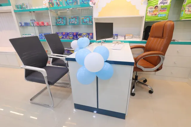 Balloons brighten the desk and seating area behind the counter. — Bikram