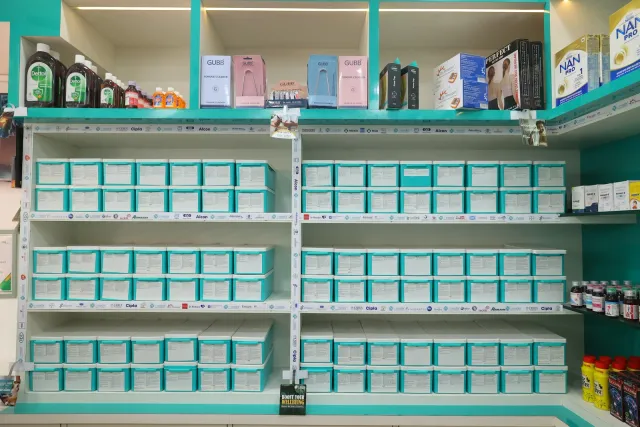 A closer view of the store's aqua drawers and product displays. — Muharram Chowk
