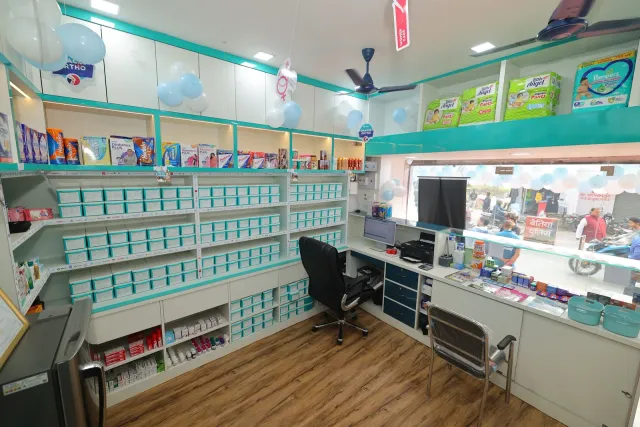 Aqua storage and glass counters create a bright pharmacy interior. — Muharram Chowk