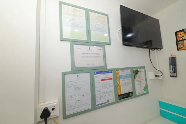Framed certificates form part of the pharmacy's interior display. — Muharram Chowk