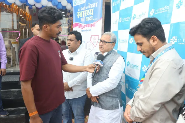 A media conversation takes place outside the decorated pharmacy. — Mohanpur, Samastipur