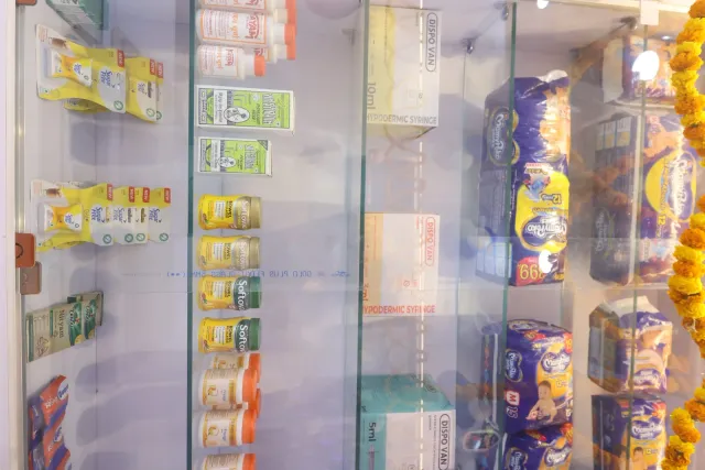 Glass-fronted shelves add another perspective on the pharmacy interior. — Mohanpur, Samastipur