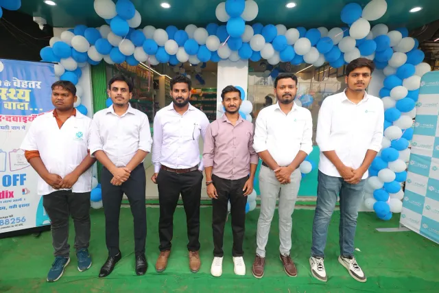 The team stands together outside the newly decorated pharmacy. — Kahalgaon, Bhagalpur