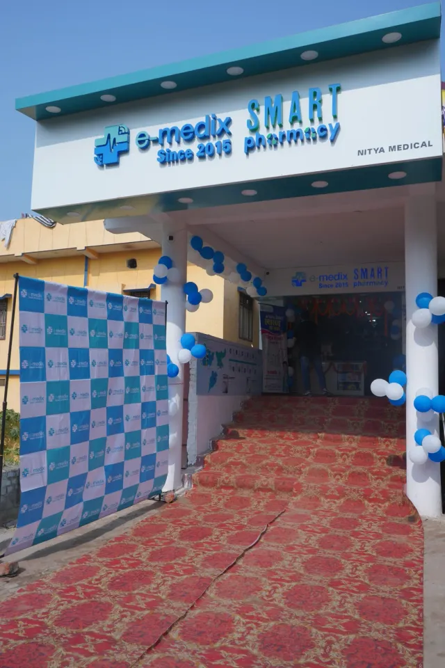 A red-carpet entrance leads into the decorated pharmacy. — Parsagarh Bazar