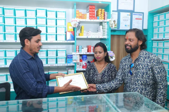 A certificate presentation marks the occasion at the counter. — Bartand, Dhanbad