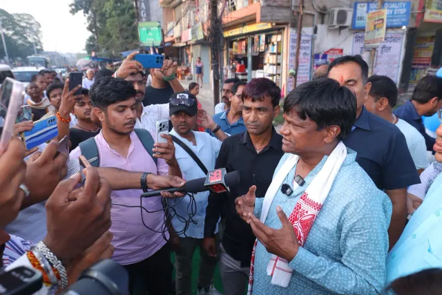 The opening draws conversations with local media outside the store. — Bartand, Dhanbad