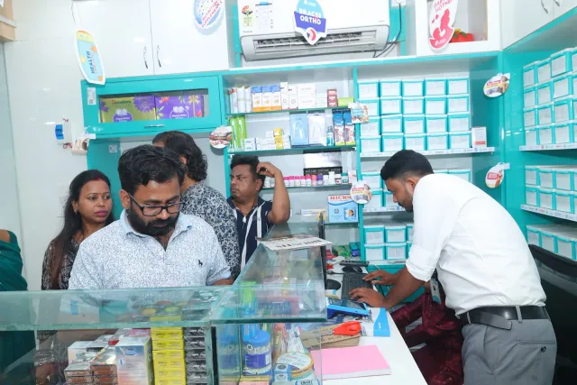 A candid look at teamwork around the pharmacy computer. — Bartand, Dhanbad