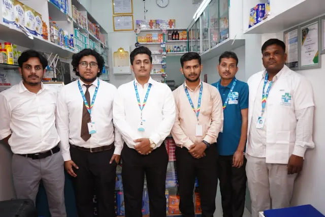 The team stands together inside the pharmacy. — Godhna Road