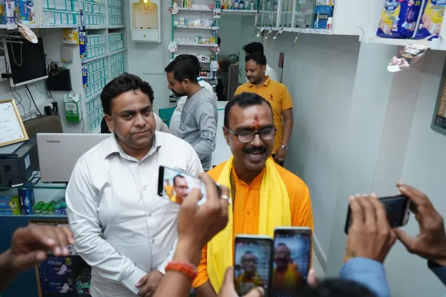 Phones come out to capture a celebratory moment inside the pharmacy. — Godhna Road