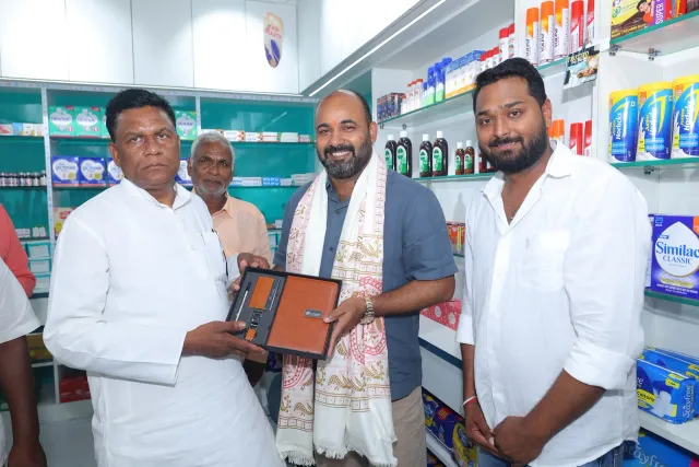 Guests share a commemorative presentation inside the pharmacy. — Simrahi Bazar