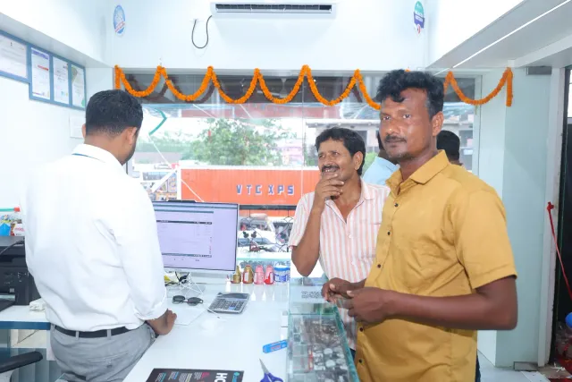 A candid moment of coordination at the computer counter. — Simrahi Bazar