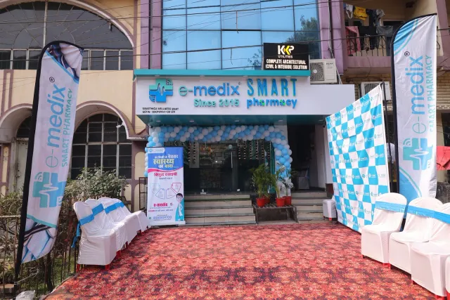 A red carpet and branded flags lead visitors to the storefront. — Sakchi, Jamshedpur