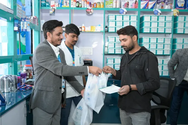 A candid bag handover takes place at the pharmacy counter. — Bariatu