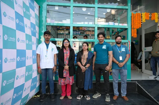 Guests pause for a photograph outside the decorated entrance. — Bariatu