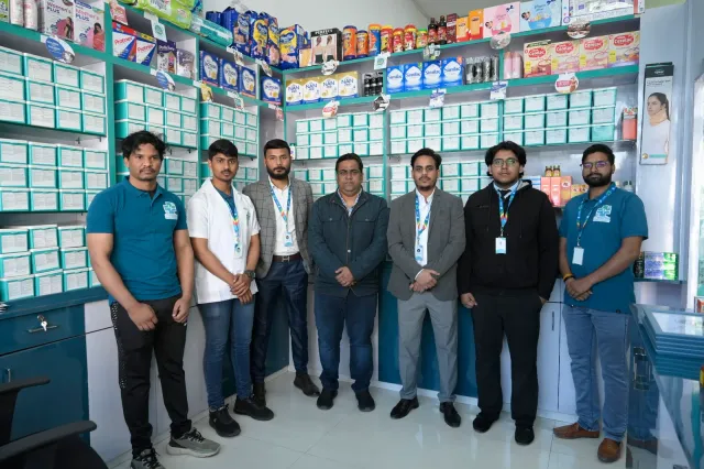 A group portrait brings the pharmacy team and guests into one frame. — Bariatu