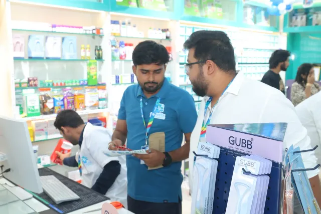 Team members check items together beside the counter. — Malahi Pakri, Patna