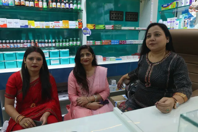 Guests pause for a photograph among the pharmacy shelves. — Malahi Pakri, Patna