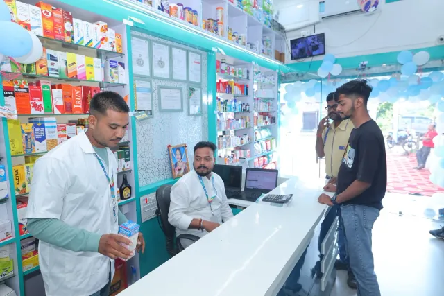 A candid moment of conversation at the pharmacy desk. — Gomia