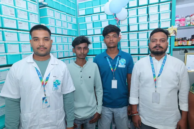 The pharmacy team poses together inside the store. — Gomia