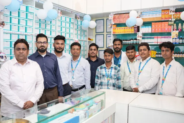 The team and guests gather for a photograph behind the counter. — Changar More Bypass