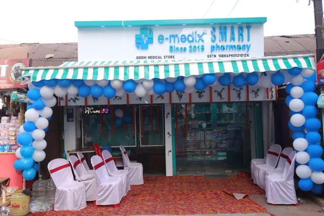 A striped awning and balloons give the storefront a festive welcome. — Jamalpur, Munger