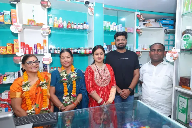 Guests pose together at the pharmacy counter. — Jamalpur, Munger