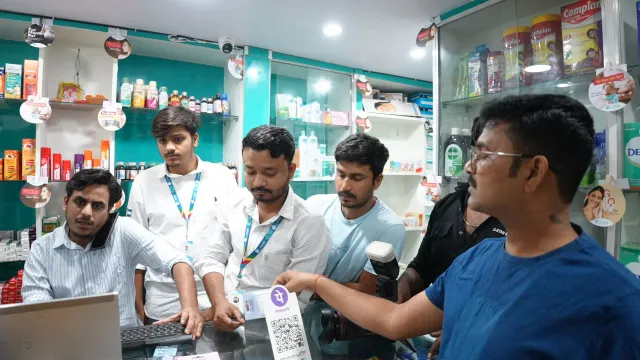 Team members gather around the computer during a working moment. — Jamalpur, Munger