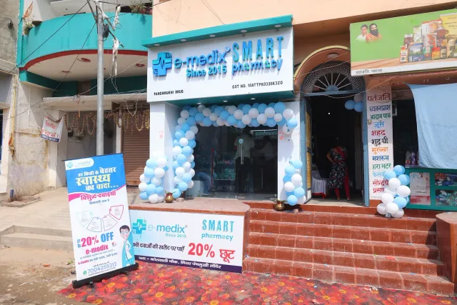 Balloons frame the entrance above the pharmacy's red steps. — Kotwali Chowk, Bettiah