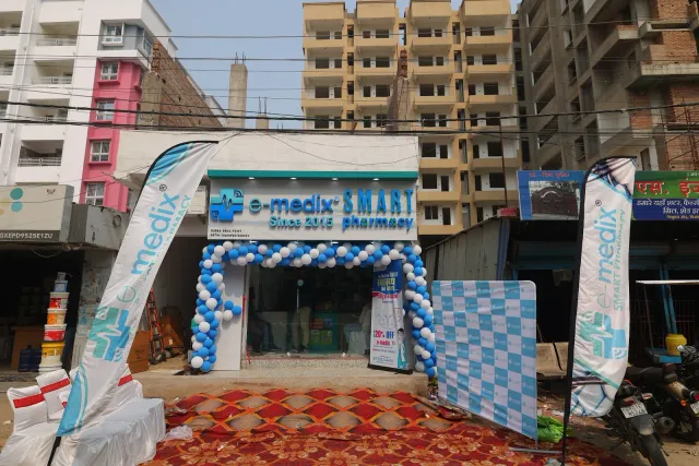 Branded flags and balloons frame the Tribhuvan More storefront. — Tribhuvan More
