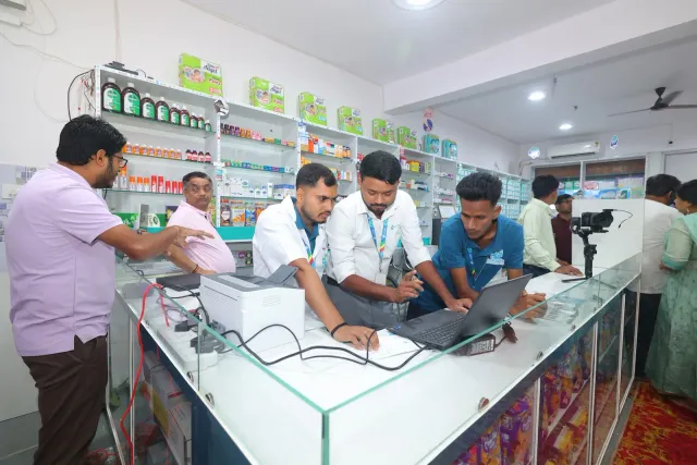 Team members gather around the laptop during a working moment. — Sonari, Jamshedpur