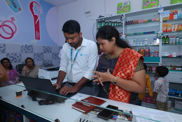 Computer work and conversation continue behind the counter. — Sonari, Jamshedpur