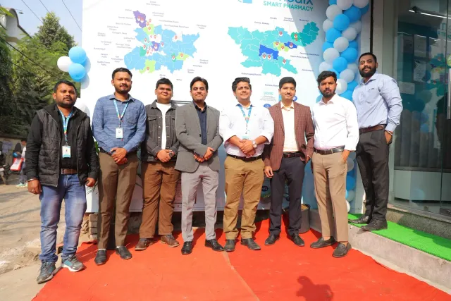 A group photograph celebrates the occasion beside the e-medix journey display. — Gardanibagh