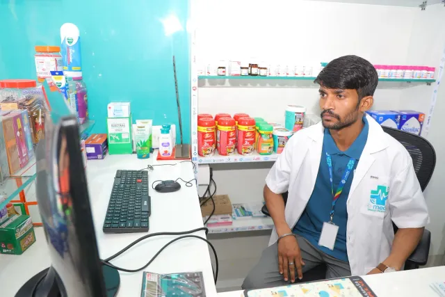 A quiet moment at the computer behind the pharmacy counter. — Gardanibagh