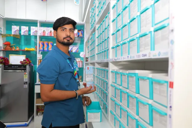 A team member checks an item beside the aqua drawers. — Gardanibagh
