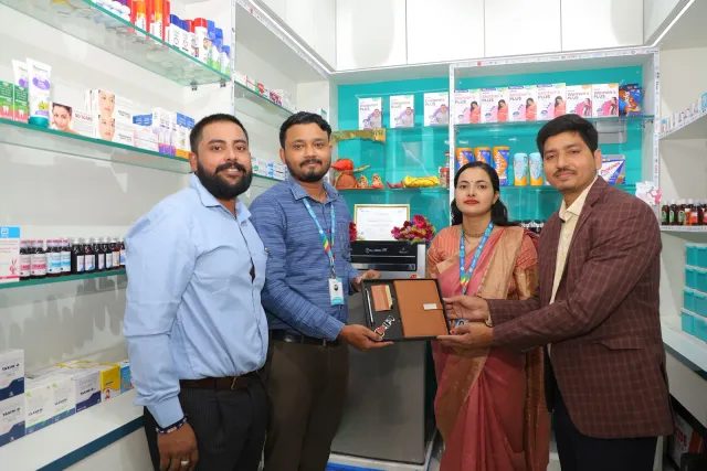 Guests share a commemorative presentation at the pharmacy. — Gardanibagh