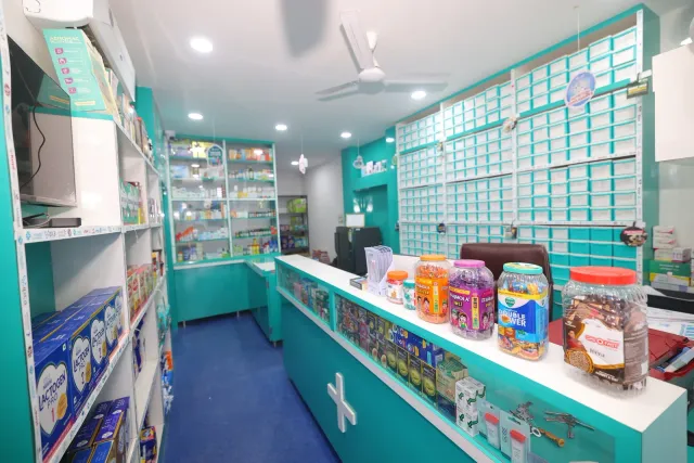 A bright counter and aqua shelves give a view inside the pharmacy. — Ashiana Nagar
