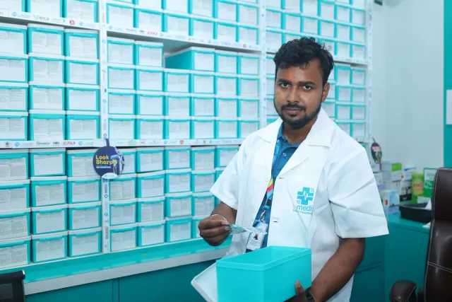 A team member checks a pack beside the aqua drawers. — Ashiana Nagar