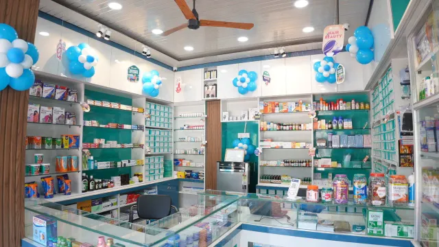 A clear view across the pharmacy's glass counters and display shelves. — Housing Colony Kankarbagh