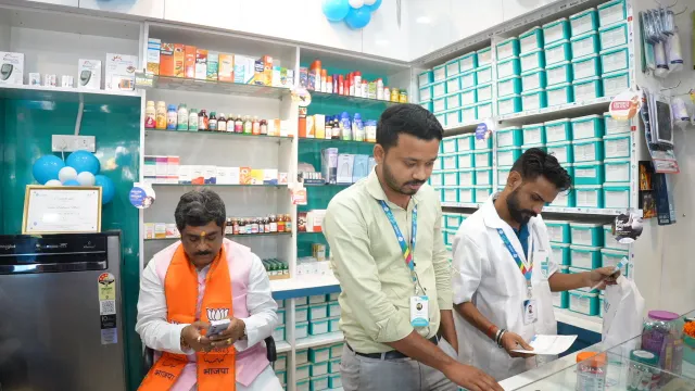 Team members review items together behind the counter. — Housing Colony Kankarbagh