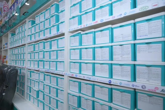 Aqua storage drawers line the pharmacy's organised interior. — Ramdayalu