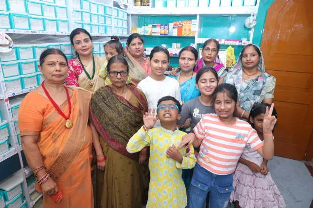 Guests share a lively group portrait inside the pharmacy. — Supriya Cinema Chowk