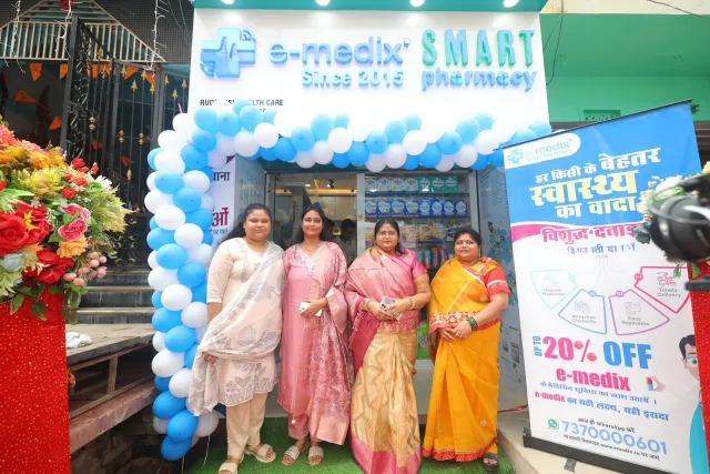 Guests pose together beneath the decorated storefront. — Arya Samaj Road, Samastipur