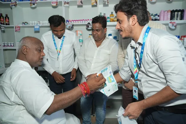 A welcoming exchange takes place at the pharmacy counter. — Balua, Motihari
