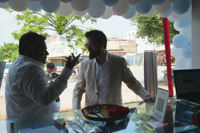 A quieter moment with refreshments beside the decorated entrance. — Balua, Motihari