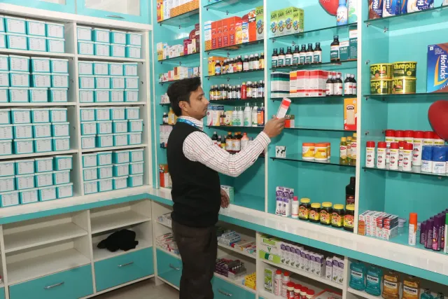 An everyday moment of organising products on the shelves. — Ramnagri Store