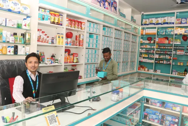 A bright counter and well-arranged shelves shape the store interior. — Ramnagri Store